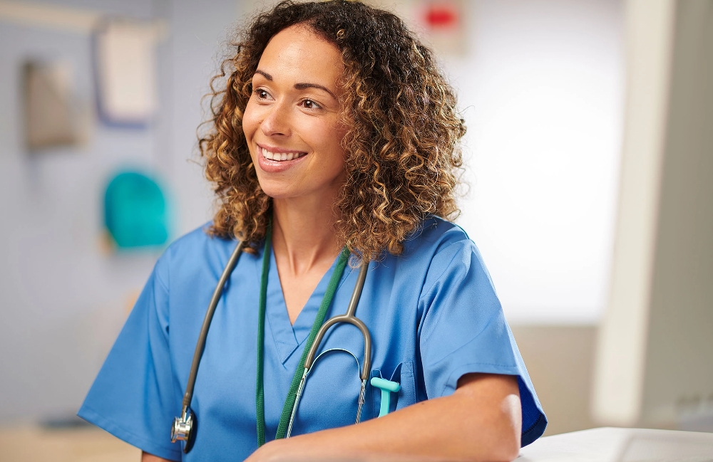 Smiling nurse with a stethoscope around her neck